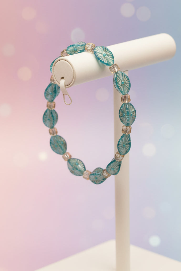 Bracelet with blue and silver beads on a teal background