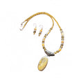 Heartfelt Creations' handcrafted jewelry set featuring a  Bumblebee Jasper and 925 silver plated pendant necklace and matching earrings.  The necklace is composed of small, faceted yellow and orange beads, a large oval-shaped, polished stone pendant with a yellow and white marbled pattern, and a decorative, ornate silver-toned metal clasp, and the earrings consisting of a single yellow bead and a smaller, matching orange bead on a silver-toned hook.