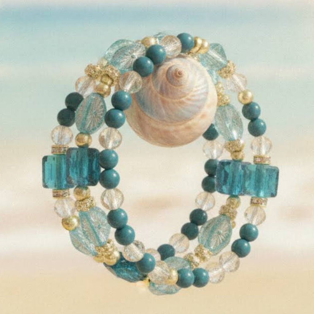 Heartfelt Creations' specialty multi wrap bracelet is a real knockout this time!  Three beaded coils  feature a mix of teal, turquoise, and clear faceted glass beads, interspersed with small gold-toned spacer beads create gorgeous accessory.  This bracelet's oceanic theme will "pop" off your wrist with charm.